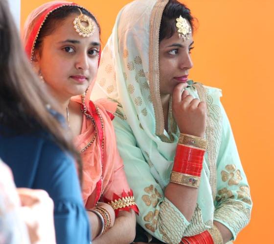 Two female international students dressed in Indian wardrobe.