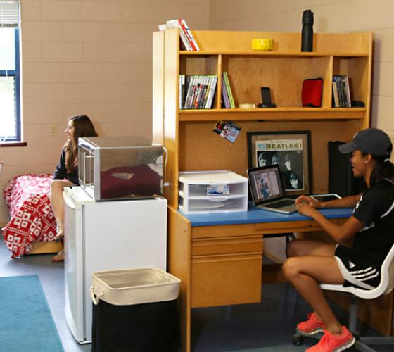 students talking and studying in residence room