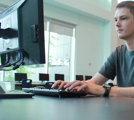 student at computer workstation