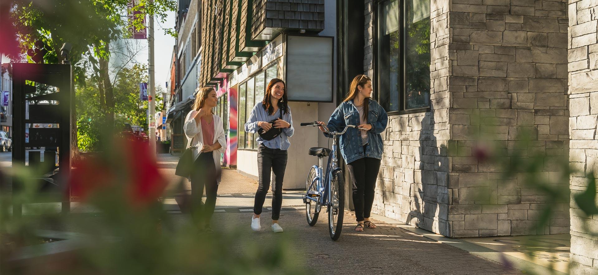 Three young women walking downtown.