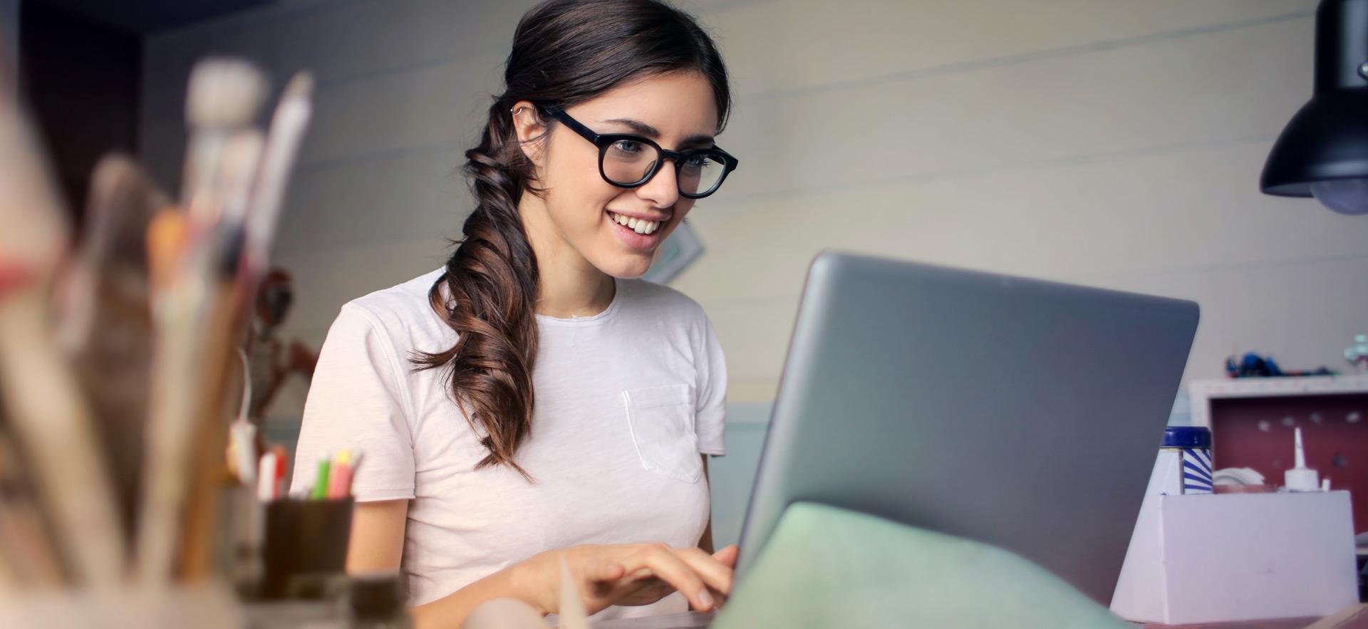young woman smiling working on computer