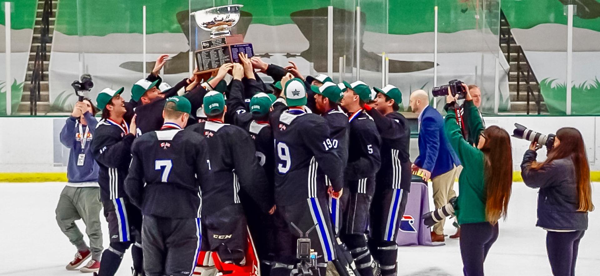 Men's ACHA Hockey Champions 2019 holding up trophy on ice