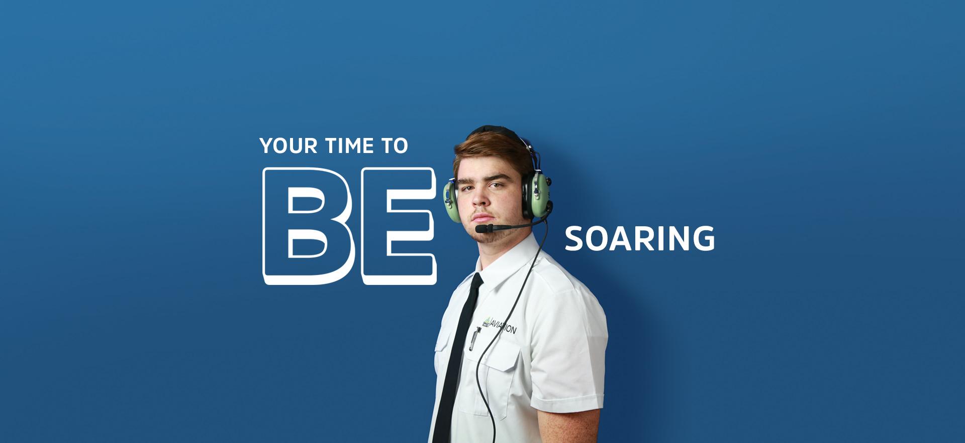 Aviation student in uniform and with headset looking at camera with text overlay YOUR TIME TO BE SOARING