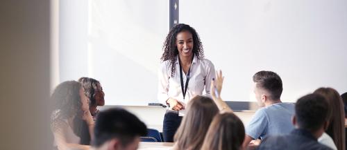 Female teacher taking questions during class.